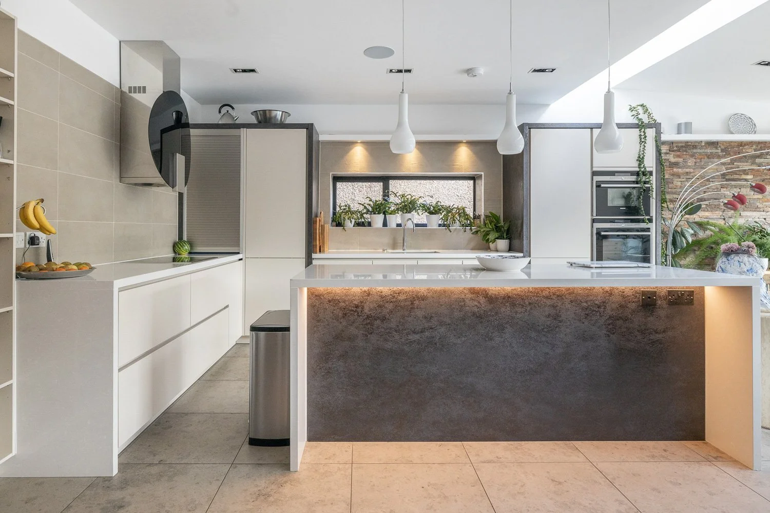 Contemporary slate and white kitchen with under lighting on the island