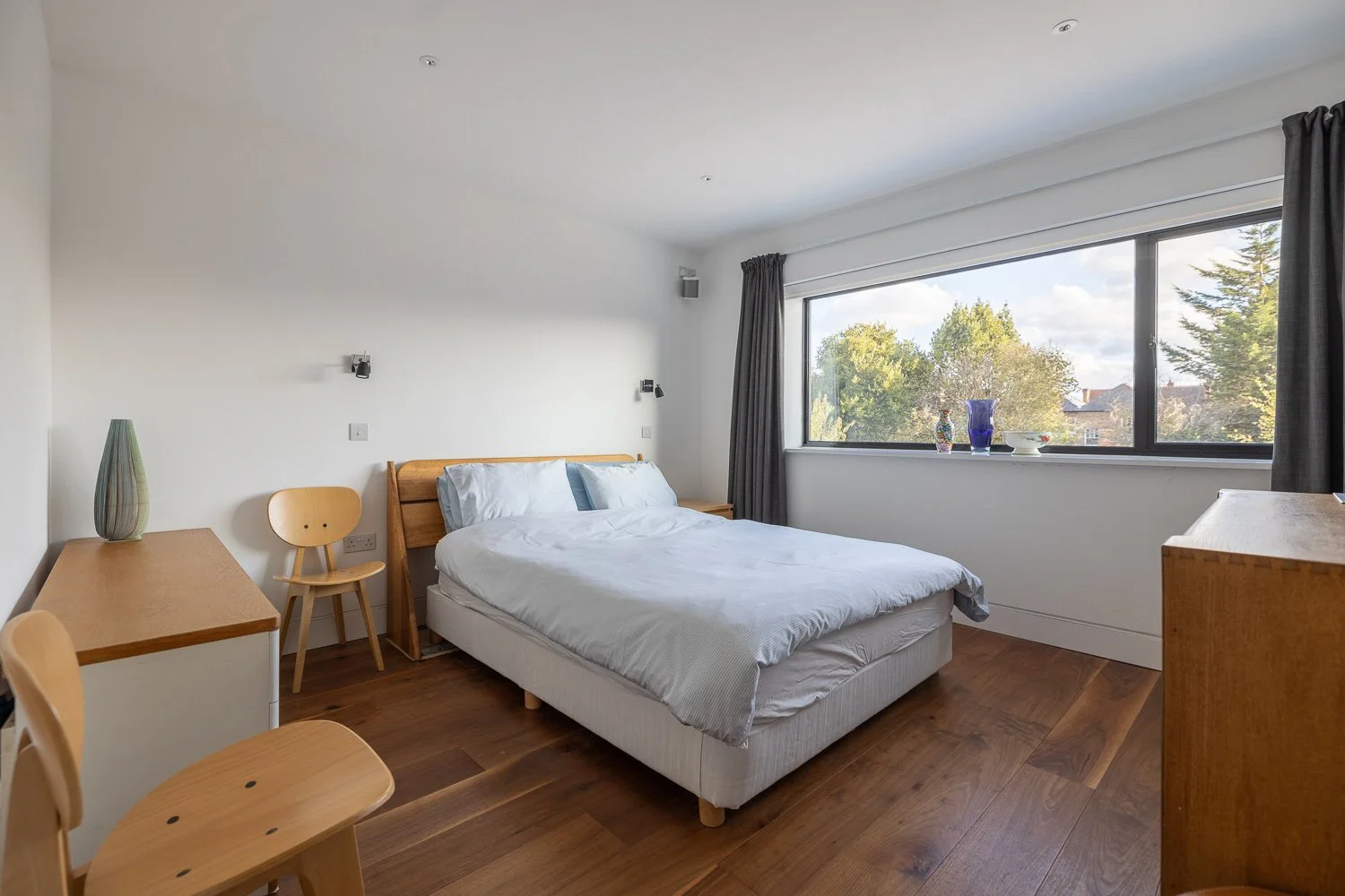 Bedroom with outdoor view and wooden floor