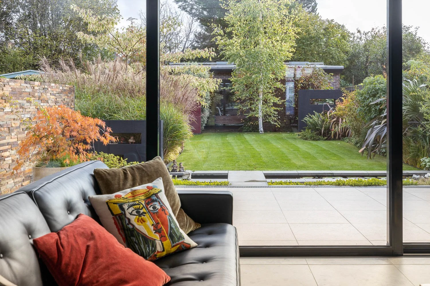 Leather sofa view over new architectural garden