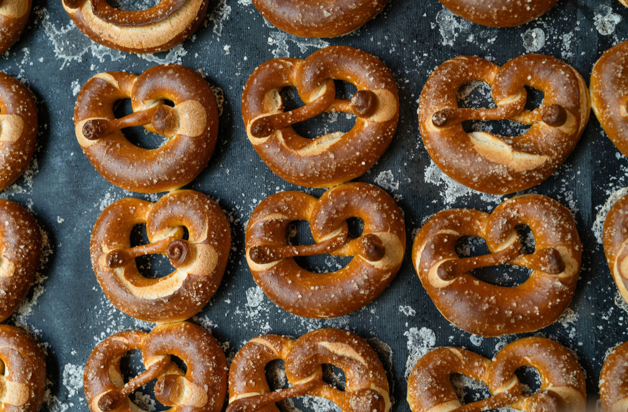 A tray full of golden baked pretzels