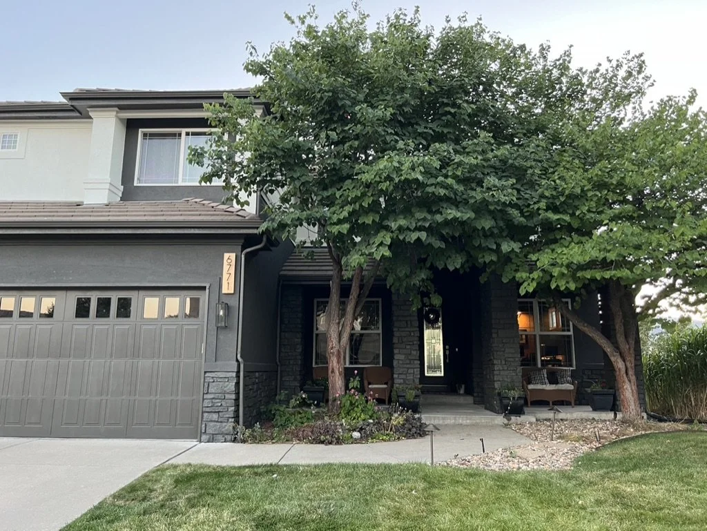 Two-story house with trees and front porch