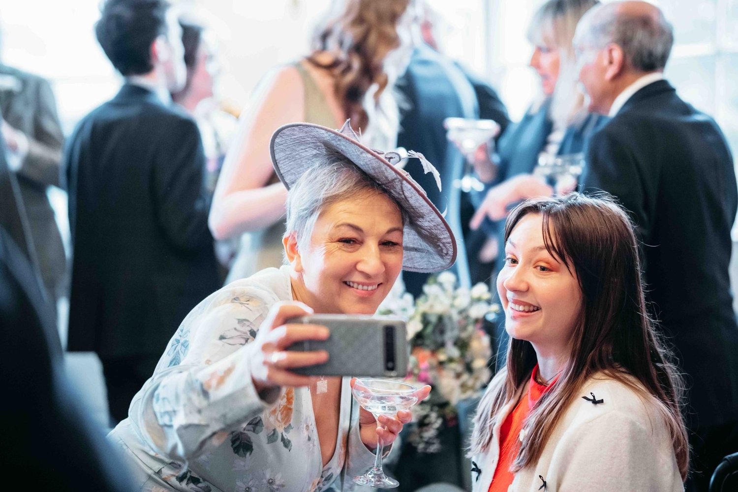 Guests laughing and taking a selfie during the drinks reception at Middleton Lodge