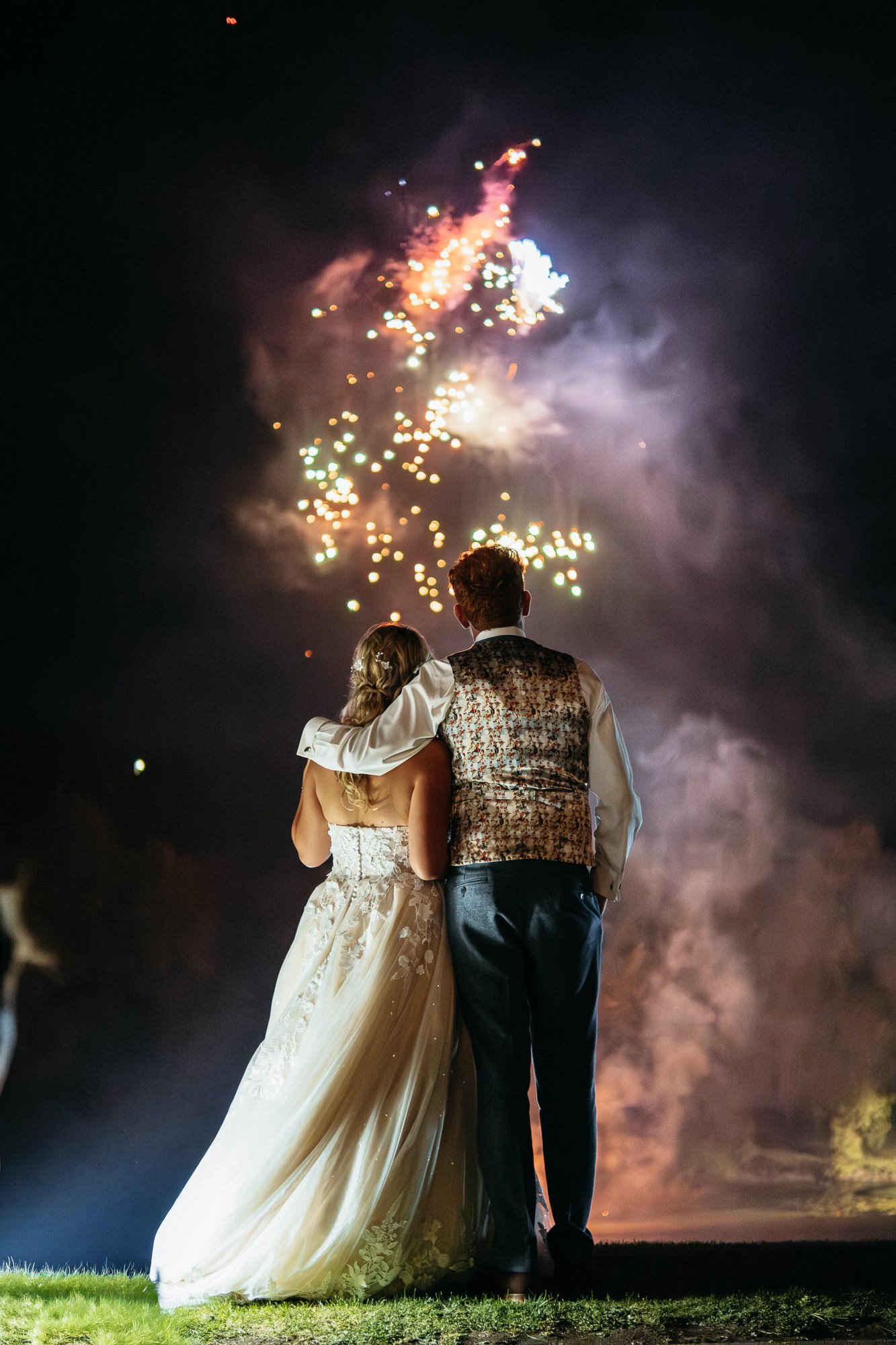 bride and groom watching the firewrorks
