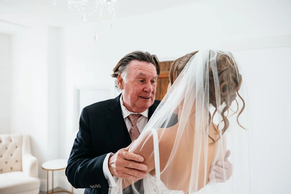 Father seeing his daughter in her wedding dress at Danby Castle