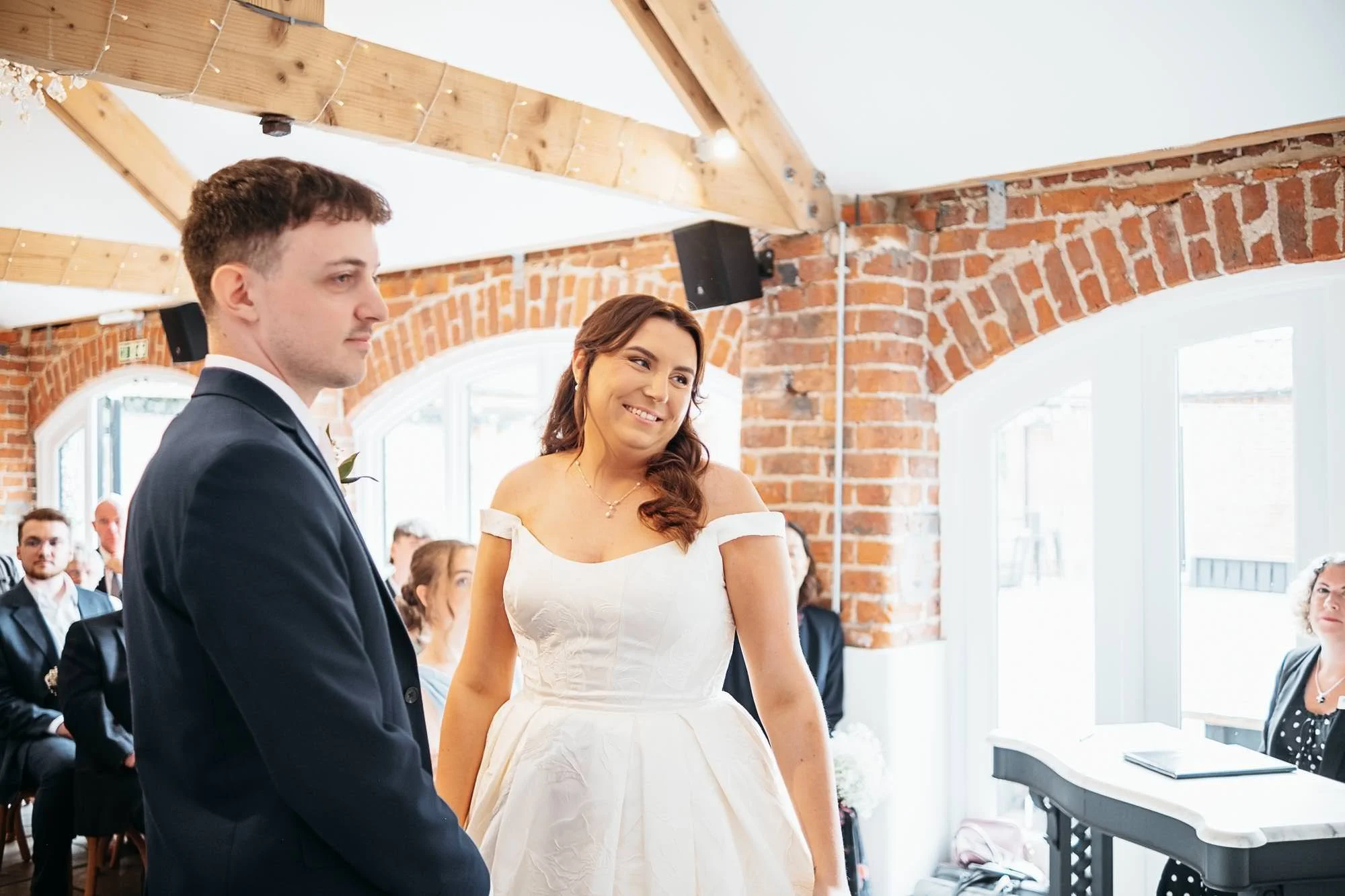 Aimee and Dan holding hands in front of the celebrant
