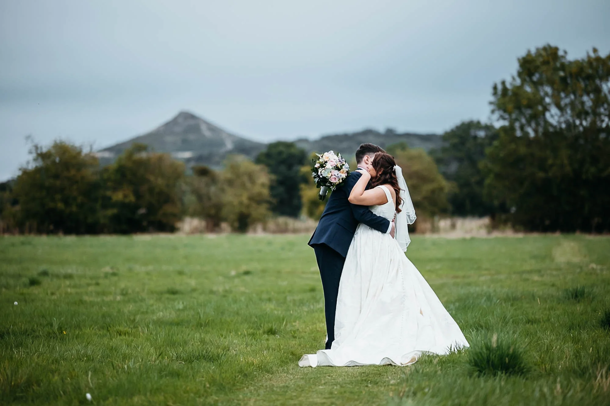 Aimee and Dan in the fields at Howard Court with the hills behind them