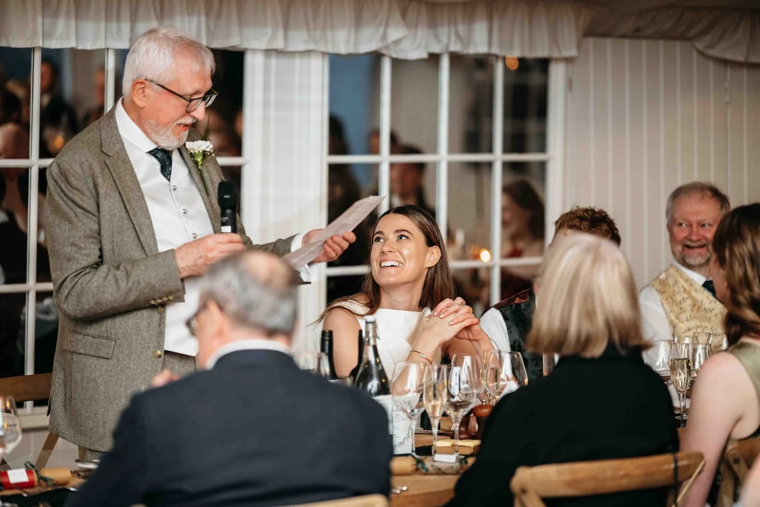Father of the bride giving his speech while the bride laughs, Middleton Lodge