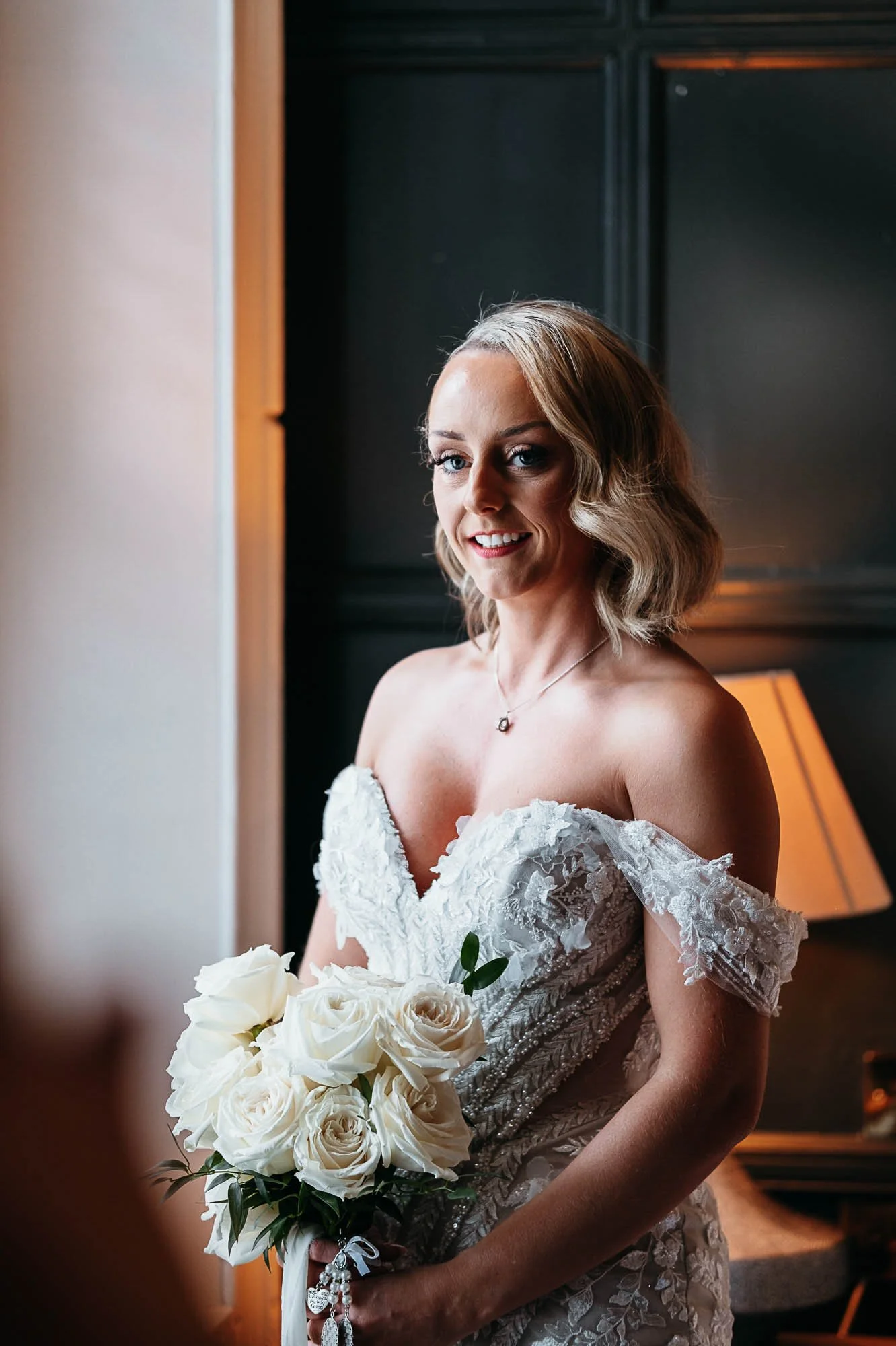 Bride photographed by window light against dark panelling at The Croft Hotel, Croft-on-Tees