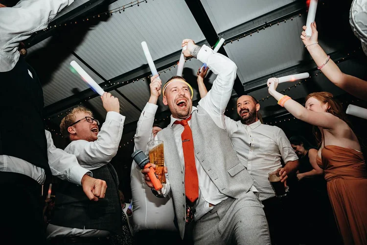 Wedding guests celebrating together on the dance floor