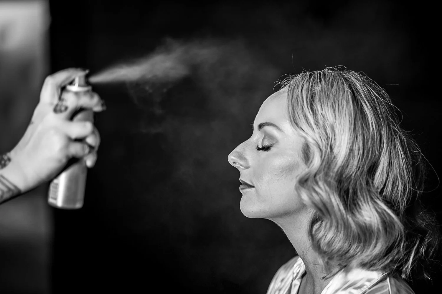 Black and white photograph of a bride having her hair finished at The Croft Hotel