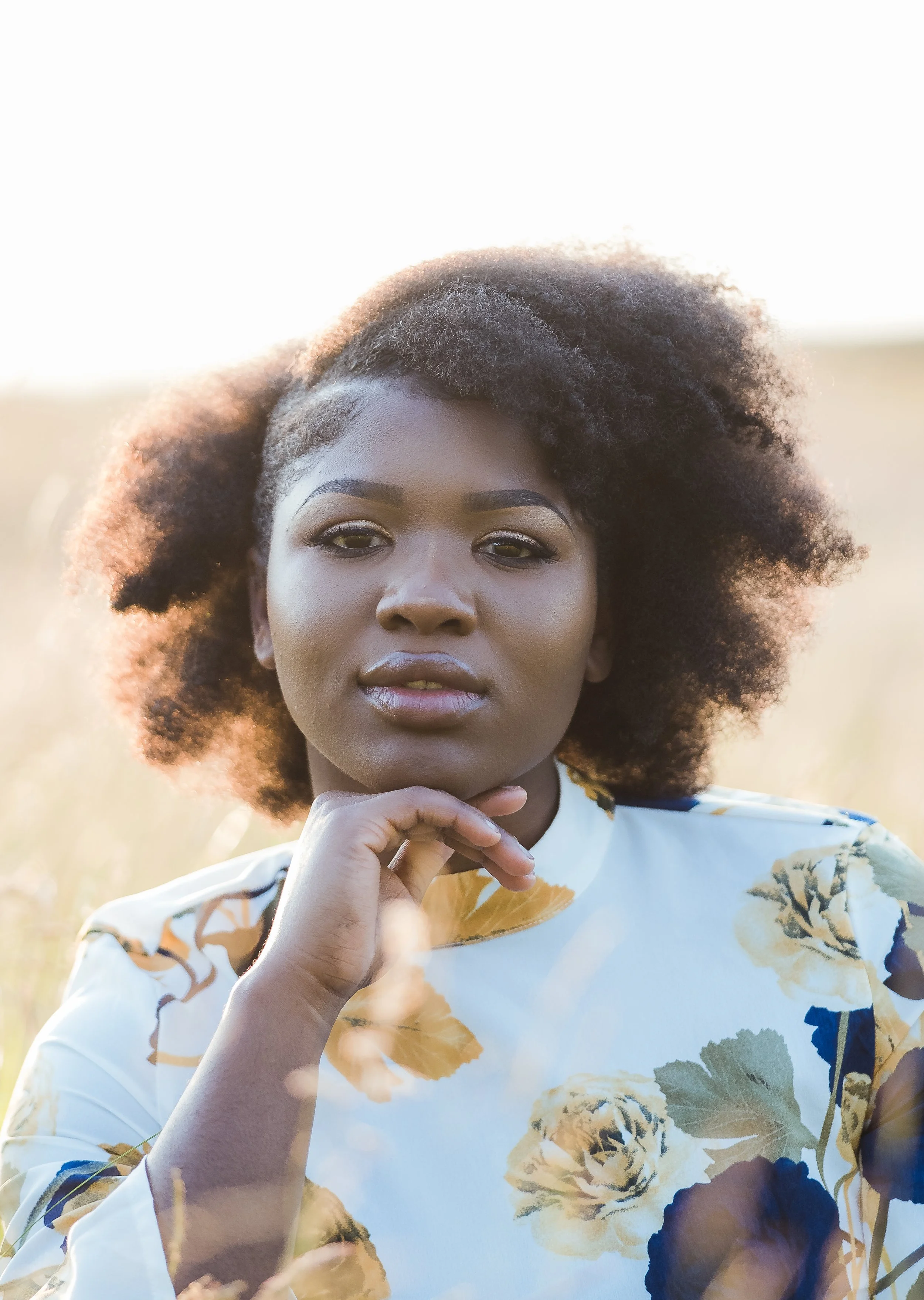 NHS worker sitting in grass during golden hour