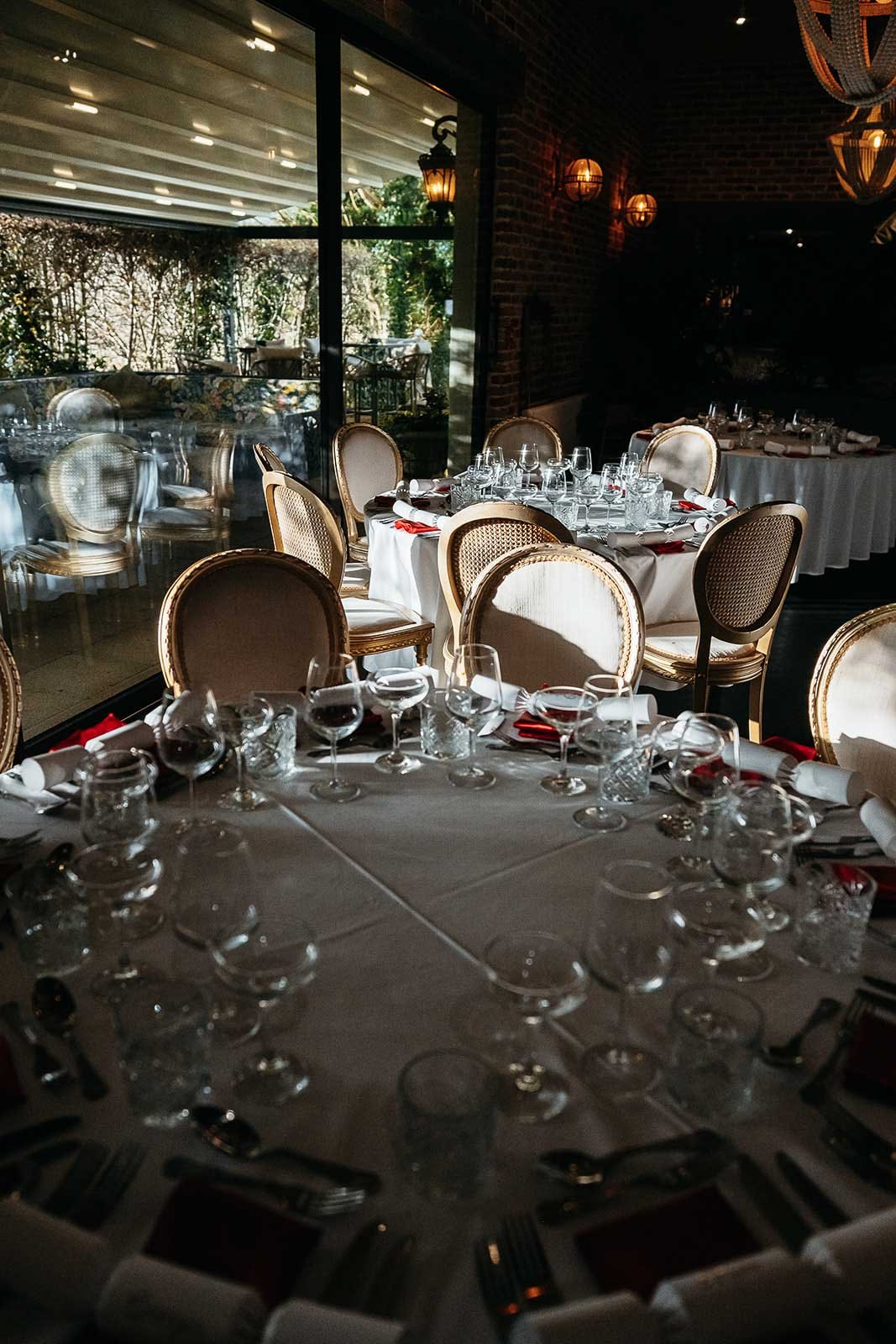 The Garden Suite at The Croft Hotel set for a wedding breakfast, with a sliding glass wall onto the garden terrace