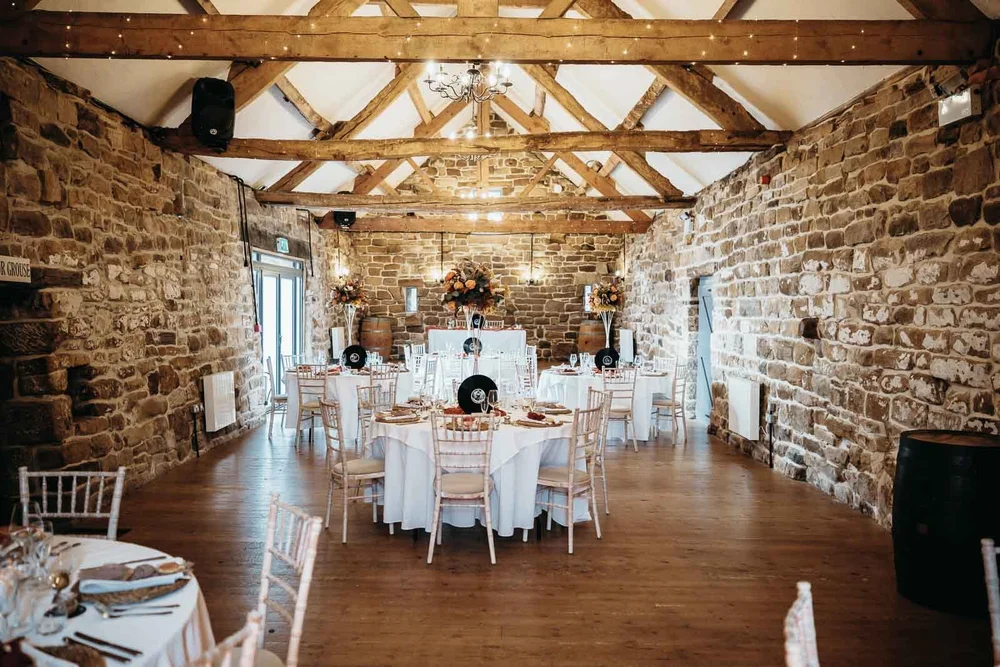 The Barn at Danby Castle with historic stone walls and timber roof beams