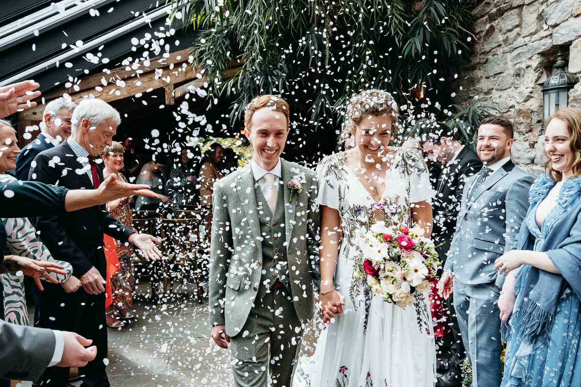 bride and groom walk in the gardens