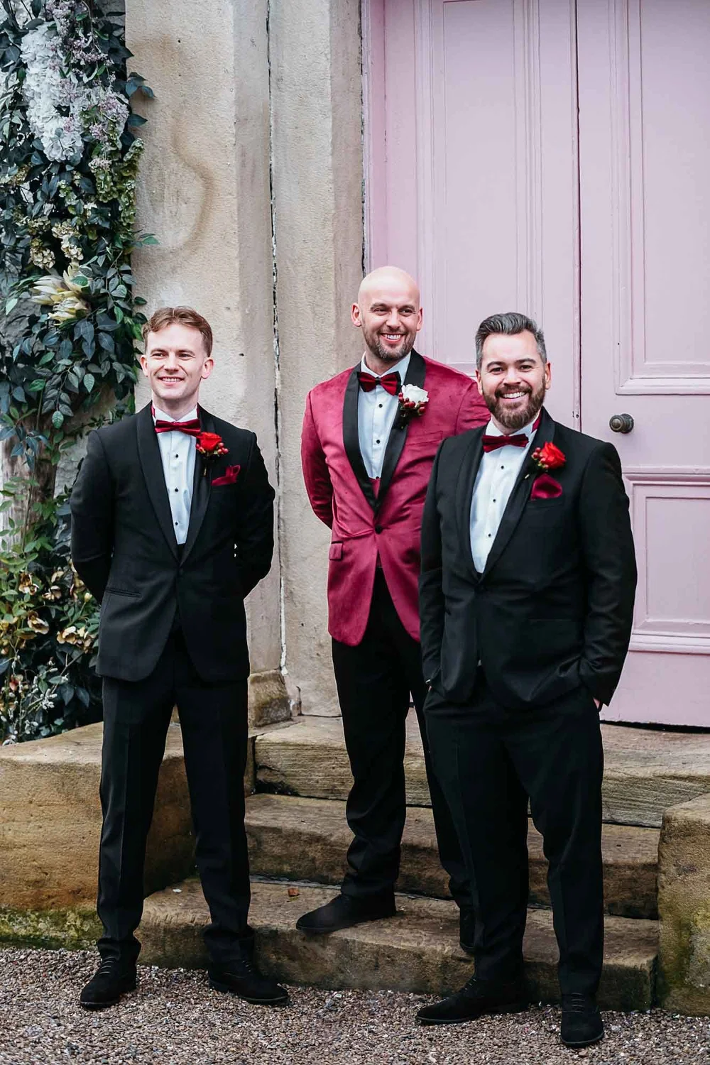 Groom and groomsmen in black tie at the pink door at The Croft Hotel, Croft-on-Tees