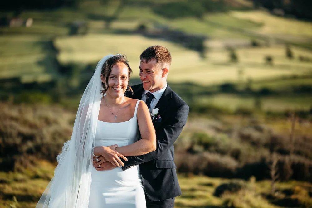 Wedding couple photographed among purple heather on the North York Moors near Danby Castle in August