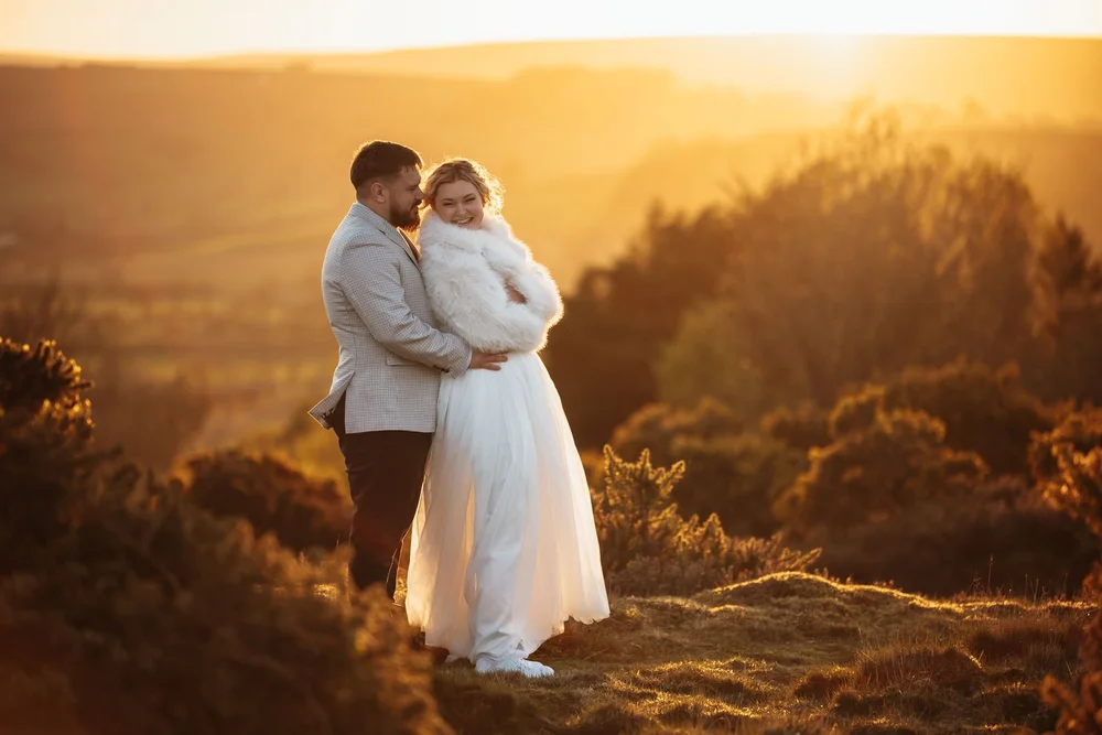 Bride and groom on the moor above Danby Castle in the last light of the day