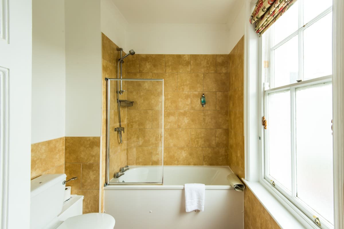 An en suite with shower over bath