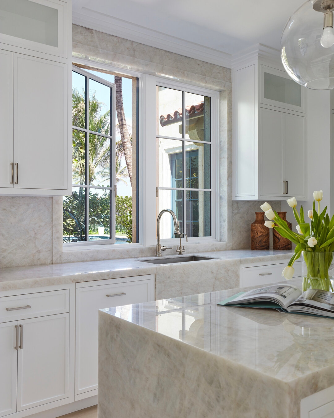 This Beautifully designed quartzite counters wraps this natural light and airy kitchen.