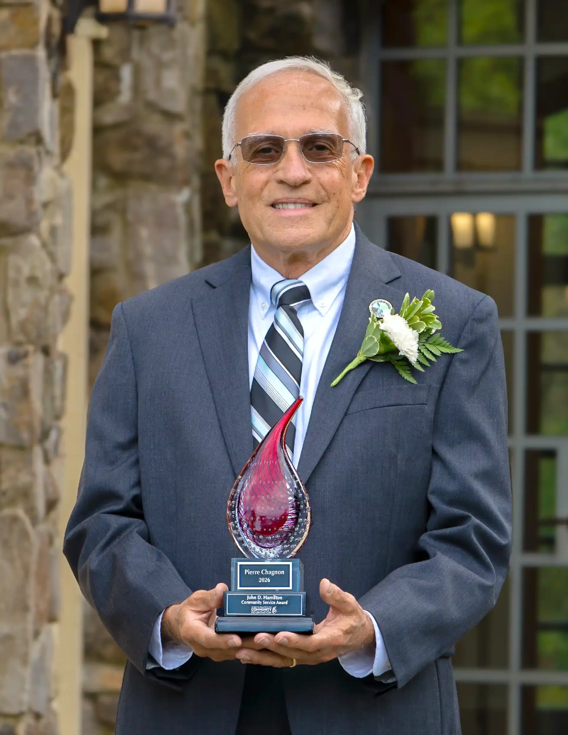 Pierre Chagnon, 2026 John D. Hamilton Award recipient, holding his award and smiling