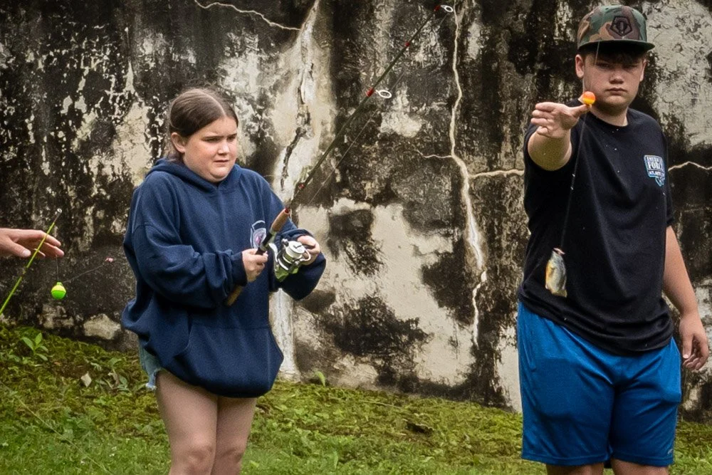 Alexa reels in a fish.