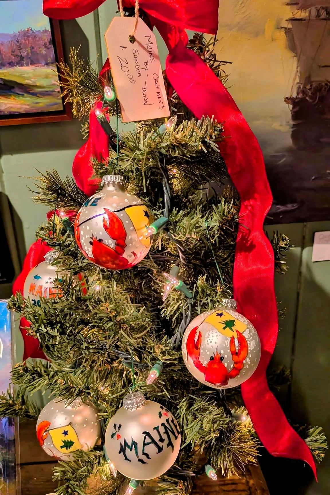 Sandra L. Dunn also has these round ornaments of The Maine flag and Lobster Available for only $20.