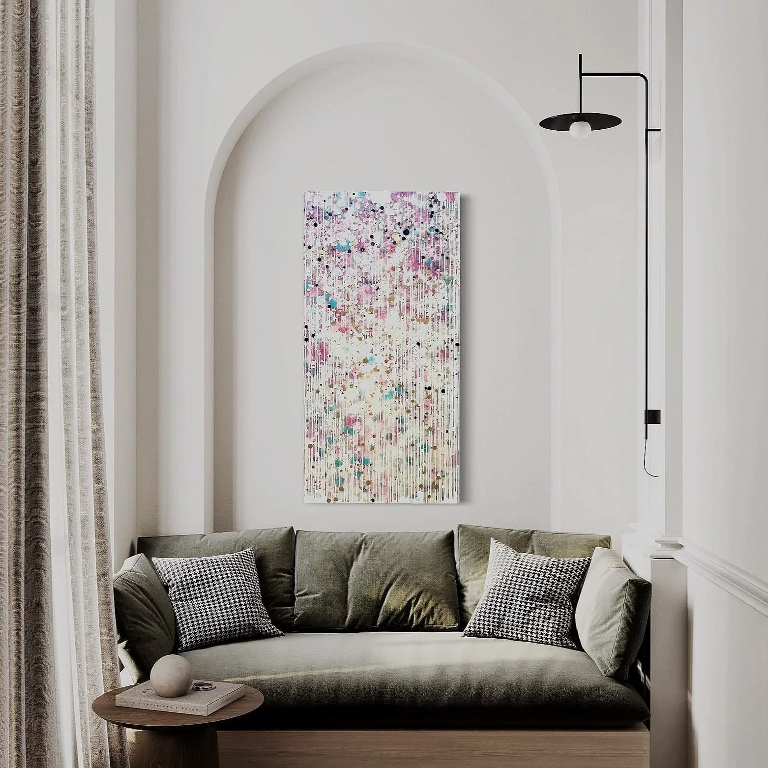 Living room with a gray couch, patterned pillows, a small round wooden coffee table with a decorative ball and a book, beige curtains, and colorful abstract artwork on the wall.