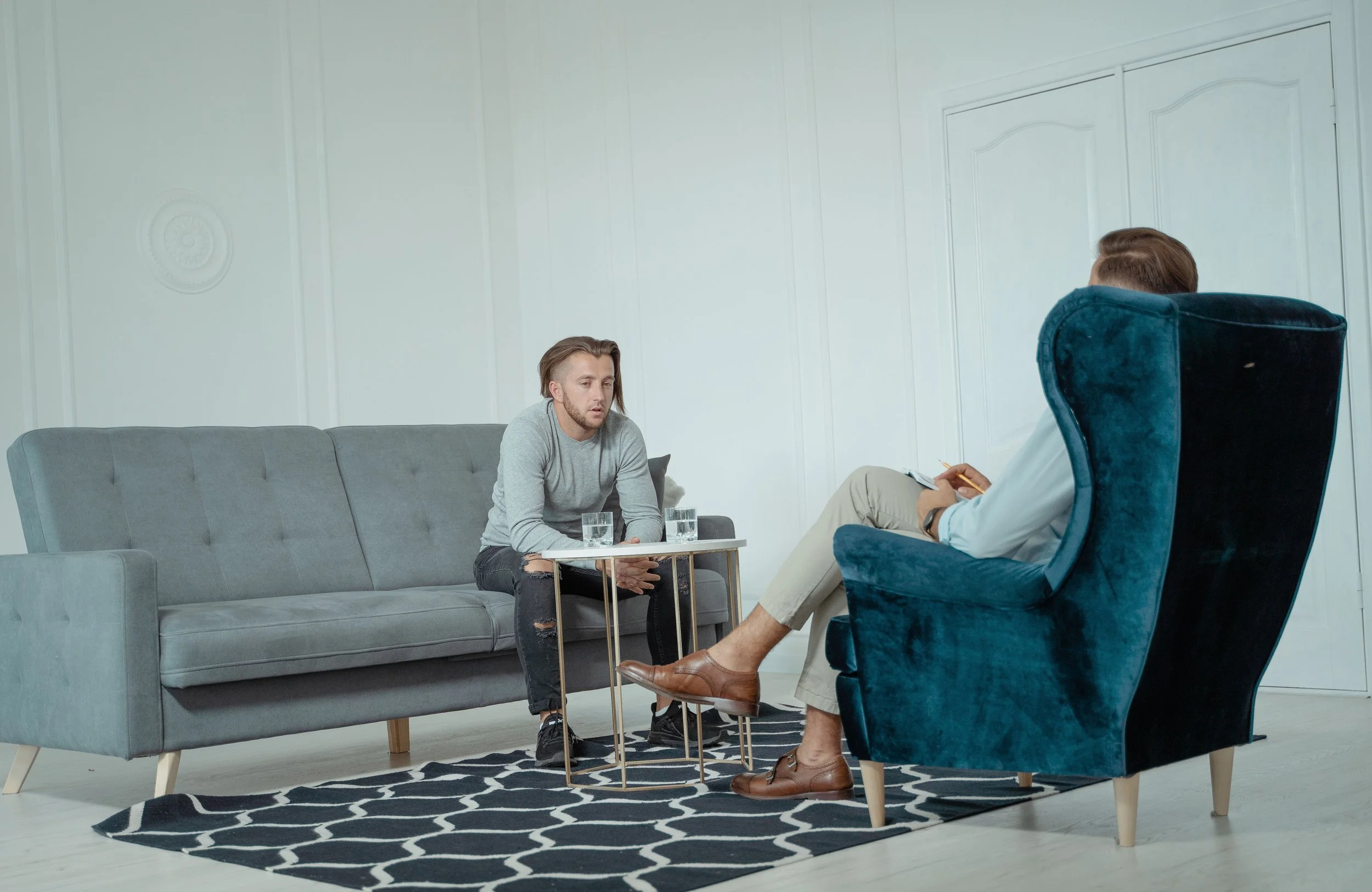Male therapist and male client having a supportive therapy session