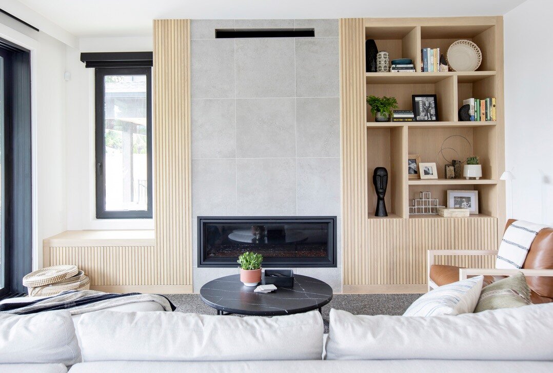 This renovation included some seriously cool built-ins that took our clients' living room to the next level. 😍

We used a mix of natural wood and black accents to create a modern yet warm feel that complements the decor. The result? A living room th