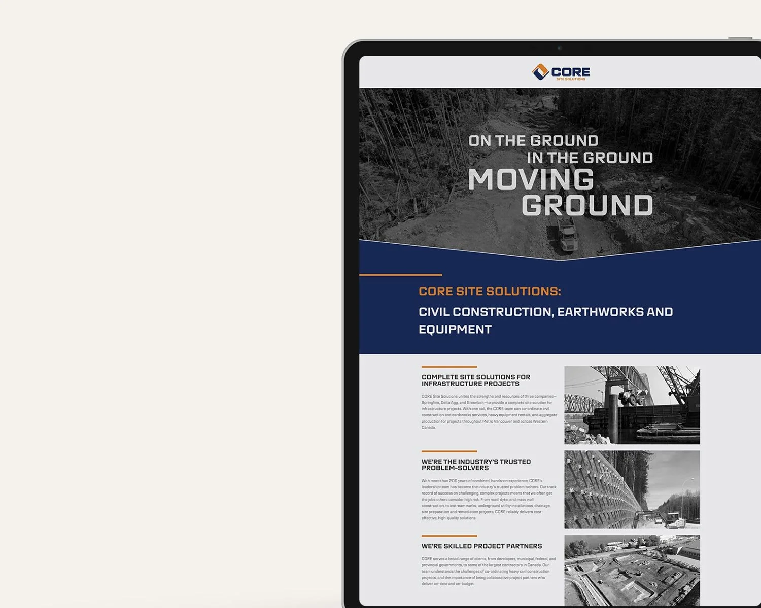 A tablet displaying a website for CORE Site Solutions, a civil construction company. The website shows a construction site with trees and dirt, along with images of construction equipment and projects.