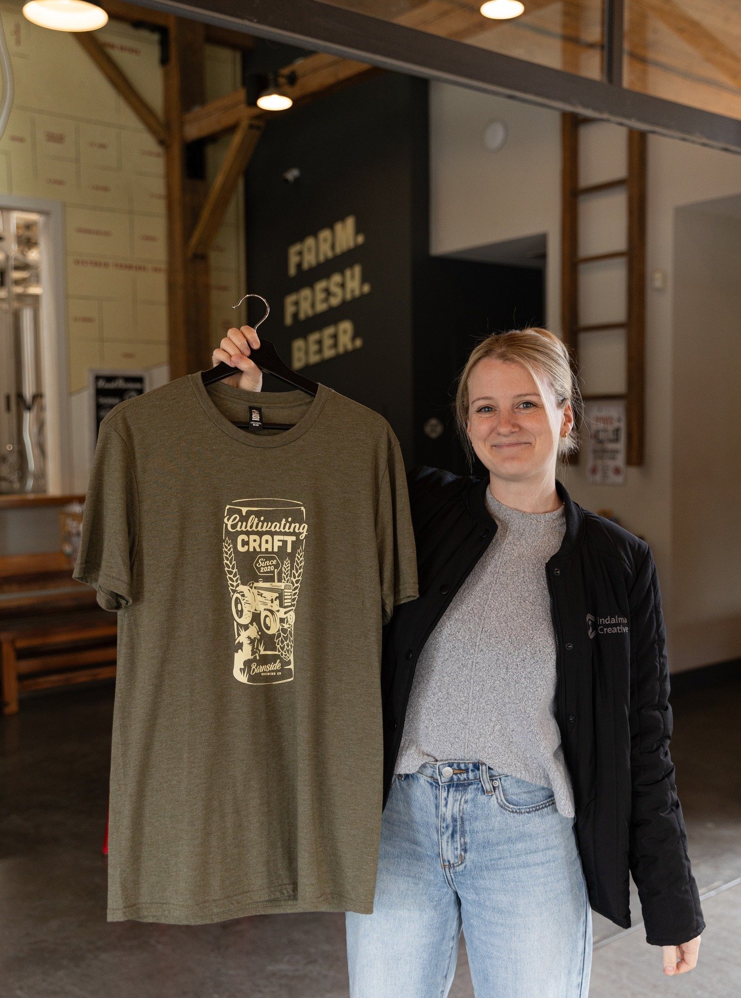 Just a designer and her work! ✨ One of the best perks of this job? Spotting your designs out in the wild. Sheri drew this custom illustration for @barnsidebrewing, bringing their 'Cultivating Craft' vibe to life!