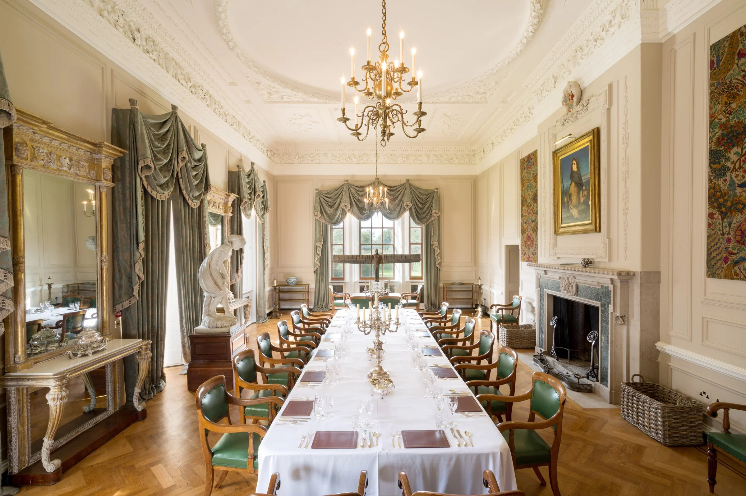 A grand stately home dining room with ornate decorations and a fully laid table inside Marchmont House, a Scottish venue promoting creativity