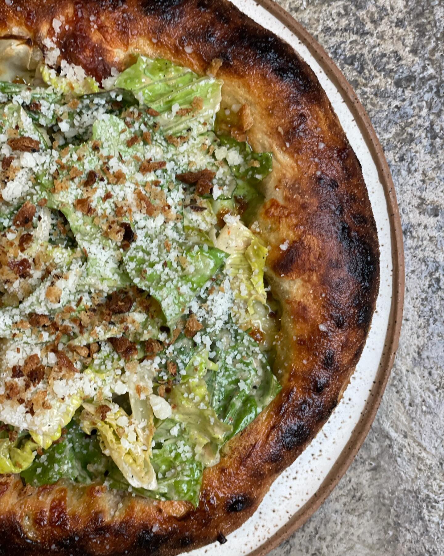 The return of one of our favorites.  The Caesar salad pizza is back for a couple of weeks.  Brave the rain and come pick one up or head the website and order delivery.

Caesar Salad - herb cream, fior di latte, onion, anchovy, sourdough bread crumbs