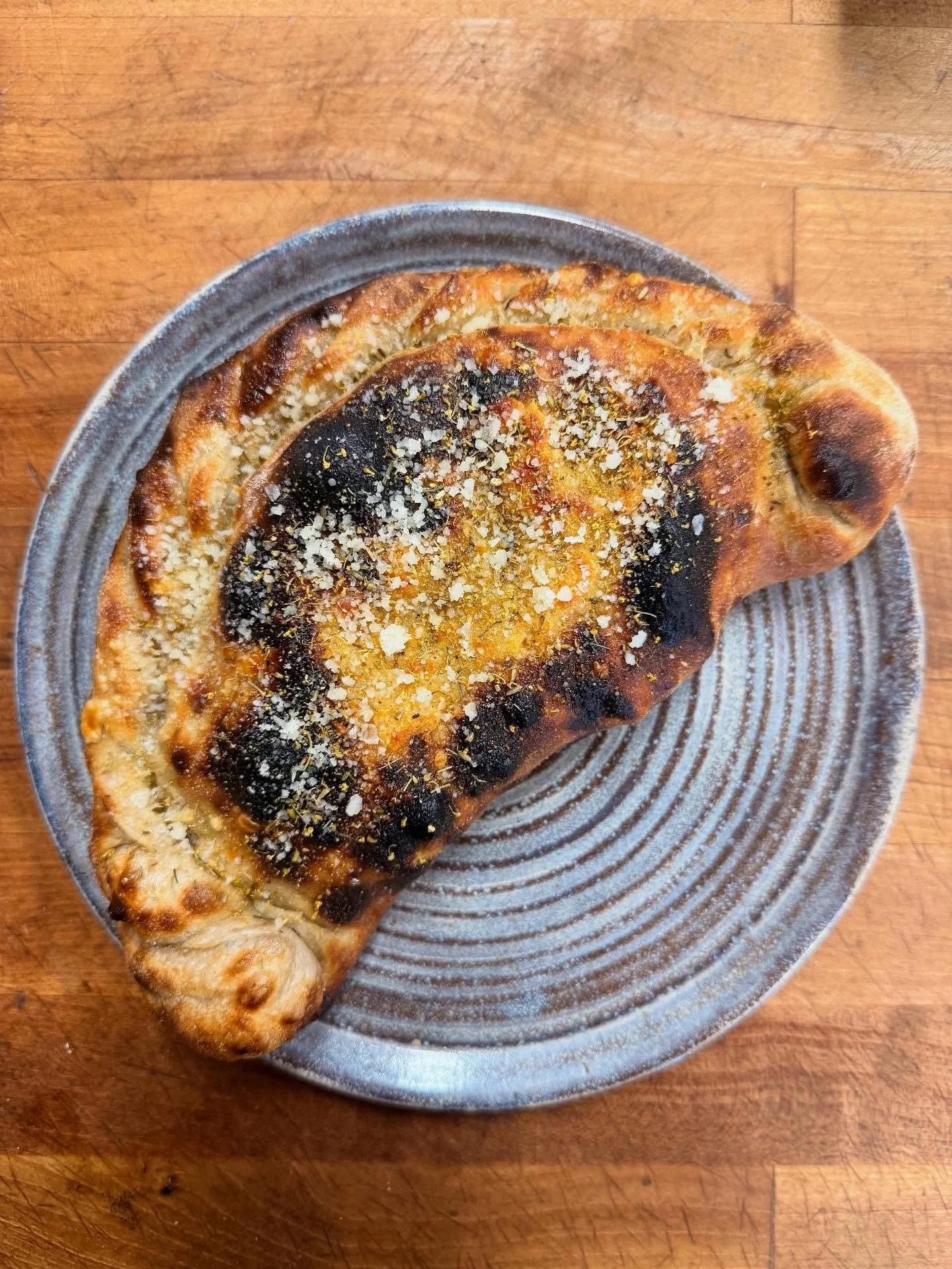 New calzone today.  Panouzzos are also on.  Come grab some lunch.
Calzone - gabagool, roasted eggplant, basil pistachio pesto, mozzarella, sotocenere