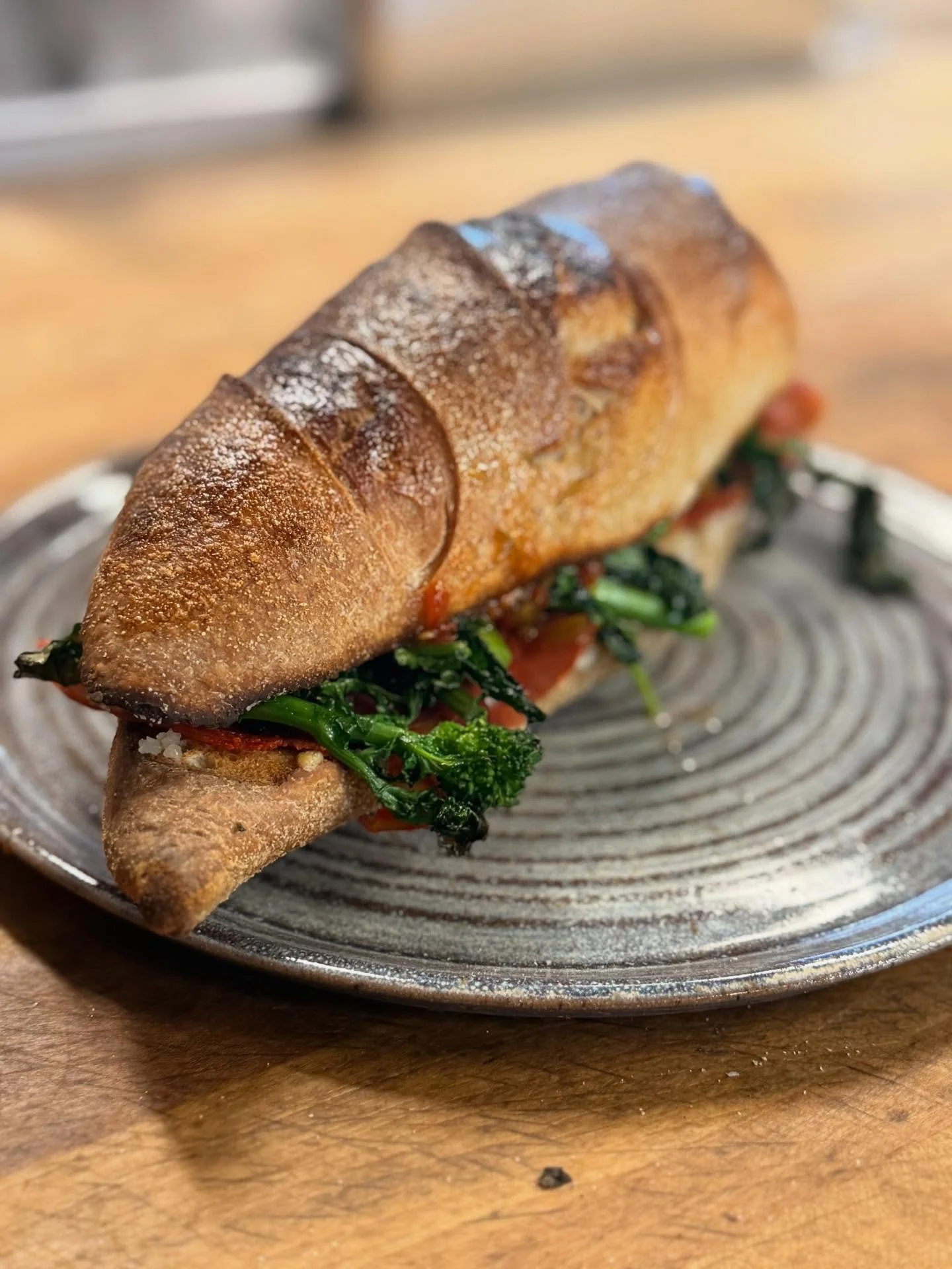 Baguettes are Back!  Melty provolone, roasted broccoli raab, spicy coppa, sweet and spicy pepper relish on our organic baguette.