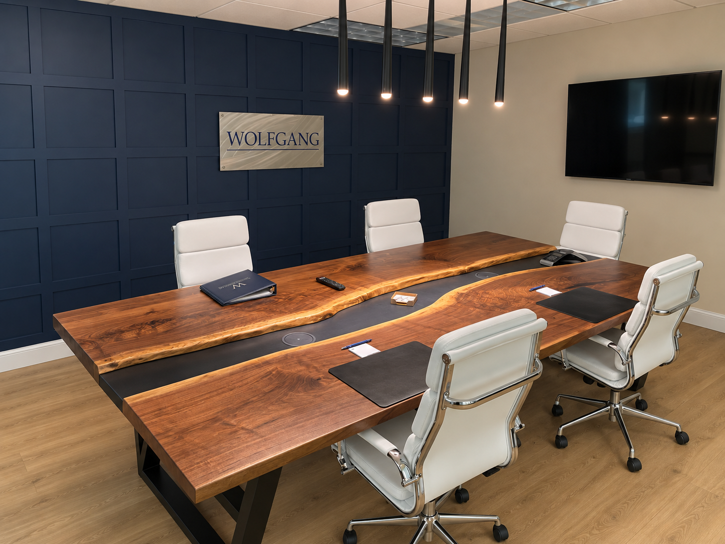 Wide walnut conference table, softly lit.png