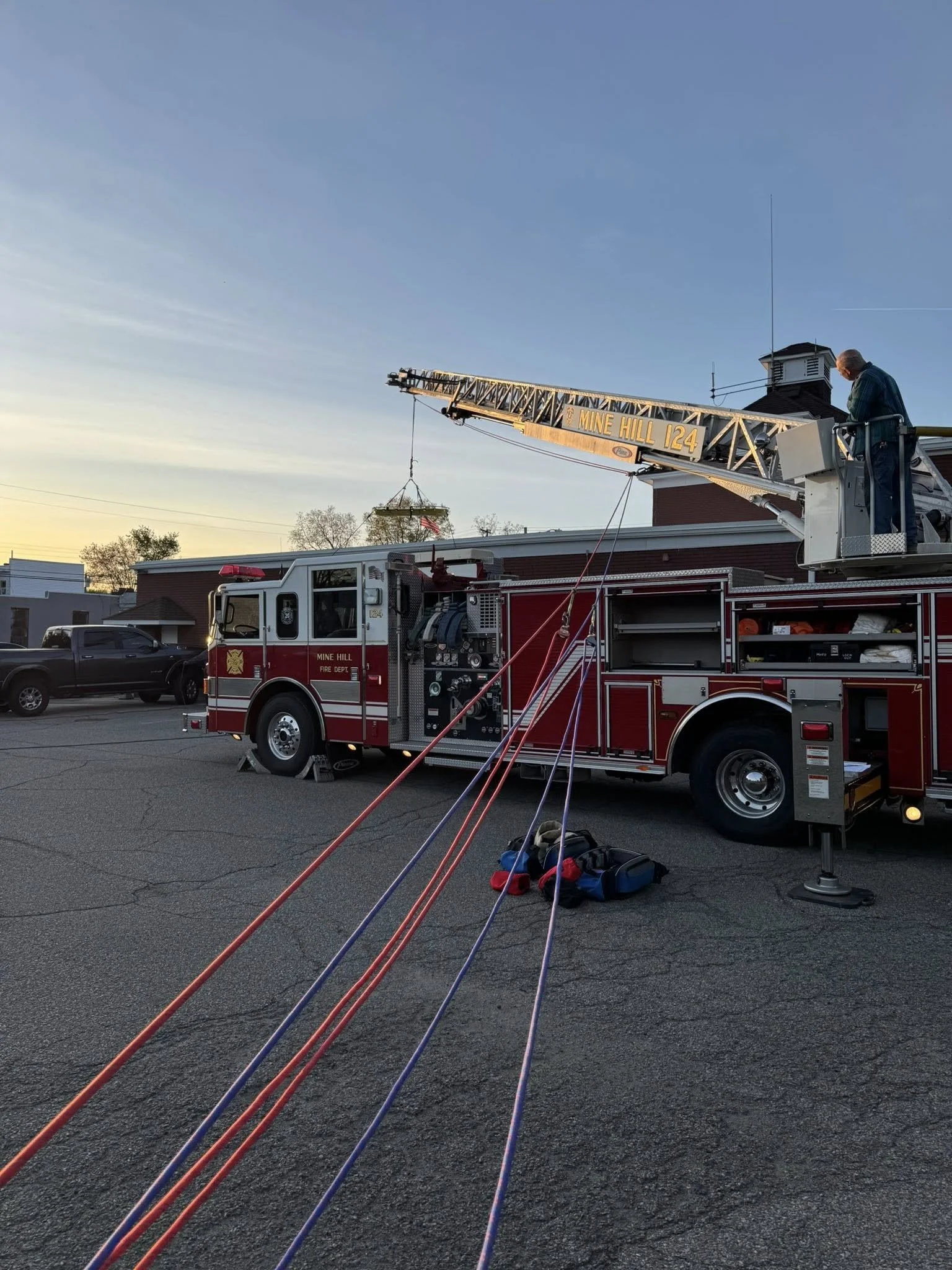 Members utilizing the aerial device and rope systems for stokes basket operations.