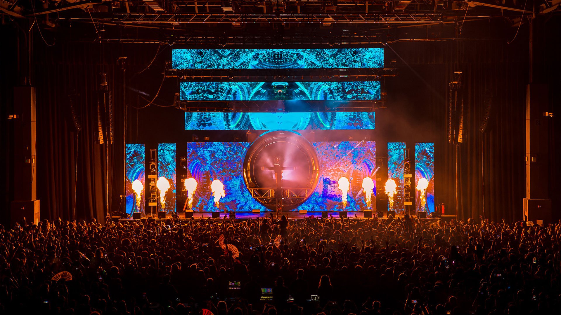 Subtronics Fractor Tour 2022 with BNE Productions' Audio Touring Package. View of Subtronics from the crowd, with blue LED video displays and pyrotechnics.