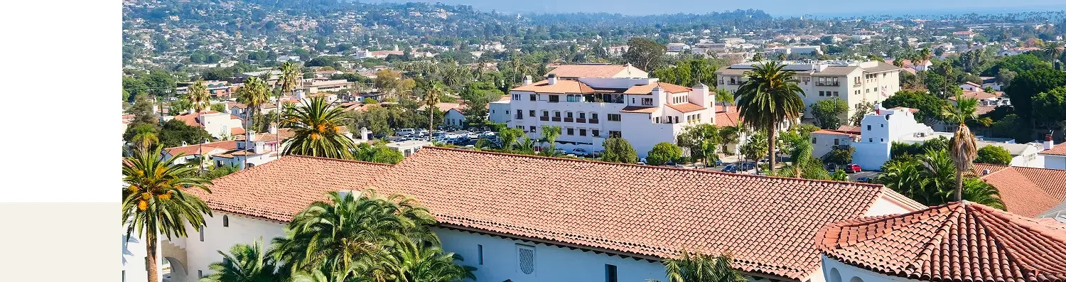 Panoramic aerial view of Santa Barbara residential neighborhood featuring traditional Spanish-style red clay tile roofs, highlighting local roofing expertise.
