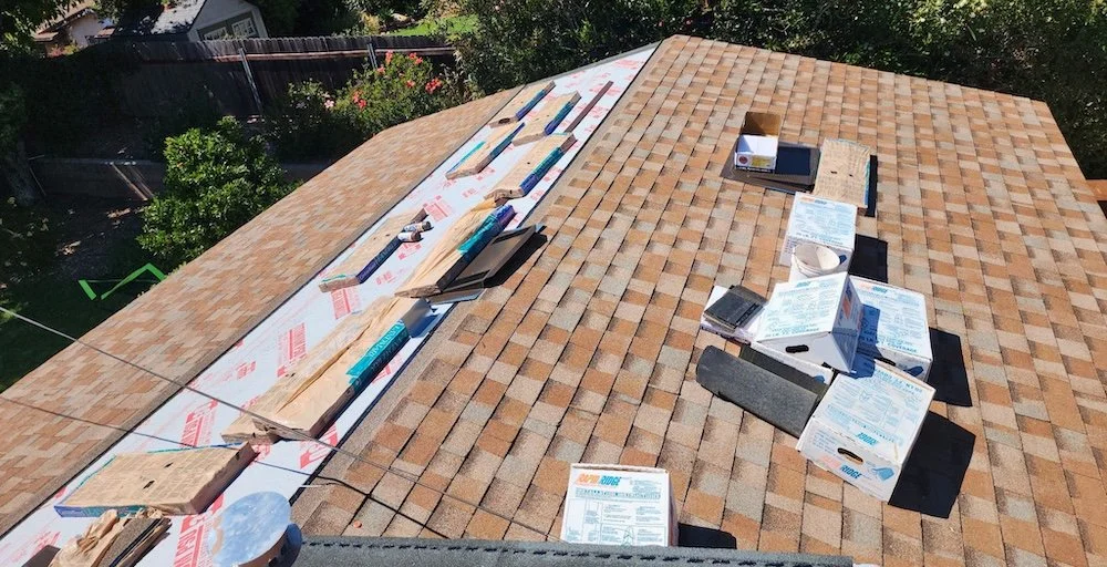 Roofing materials and Landmark Home Edition shingles staged on the roof during a replacement on a Santa Barbara home.
