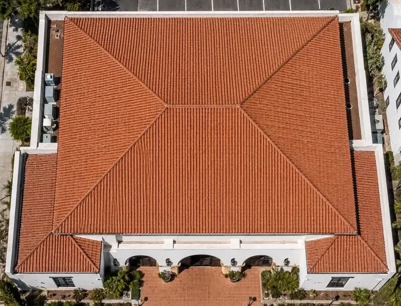 Top-down view of a sprawling commercial property with a freshly replaced clay tile roofing system.