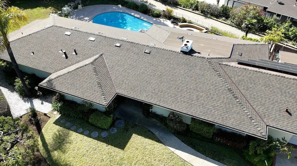 Finished asphalt shingle roof installation on a luxury Santa Barbara residence featuring clean ridge lines.