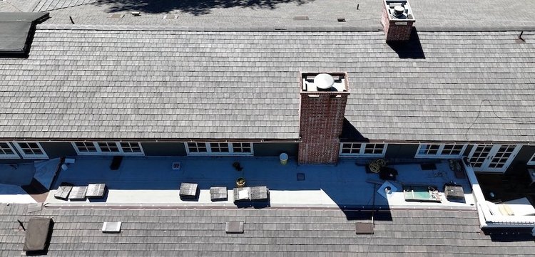Drone view of a synthetic slate roof replacement on a large single‑family home in Santa Barbara, California