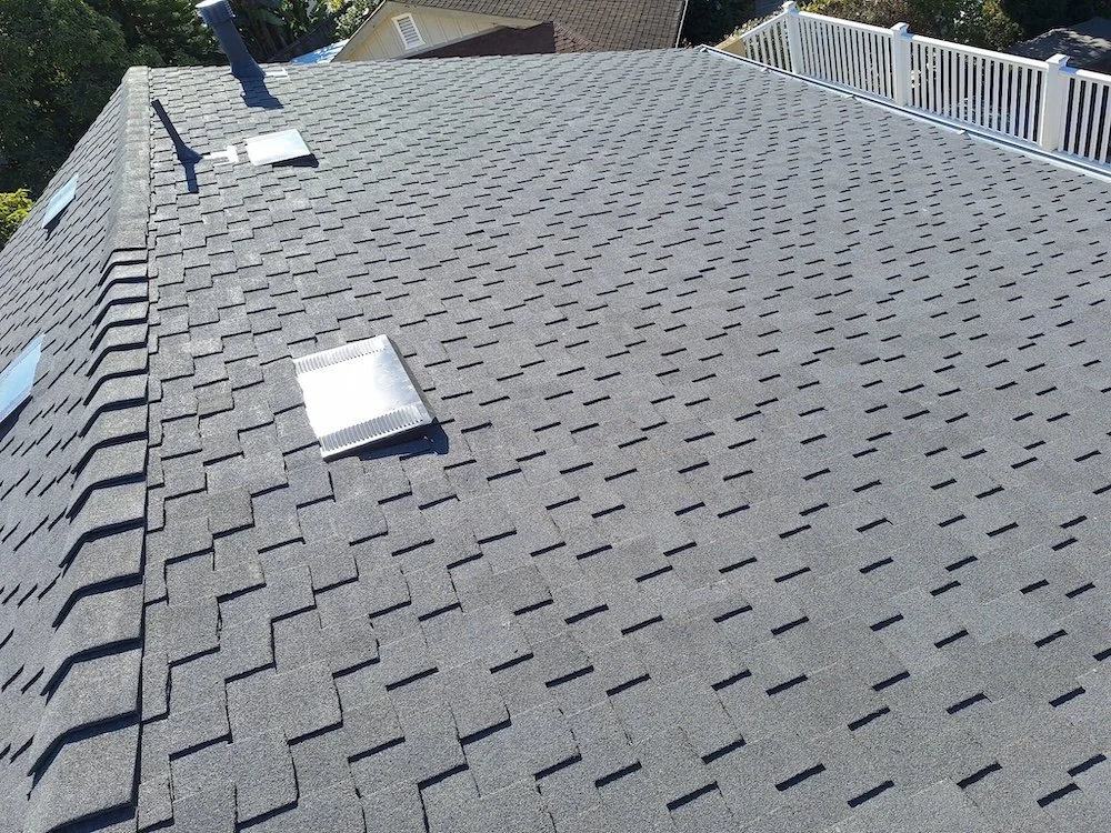 Finished Presidential‑style shake asphalt shingle roof with clean new vents on a Santa Barbara home after replacement.