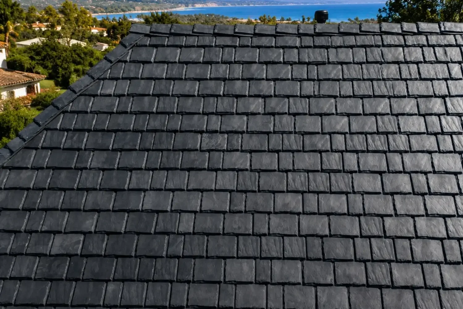 New Class A fire-rated dark asphalt shingle roof on a coastal home.