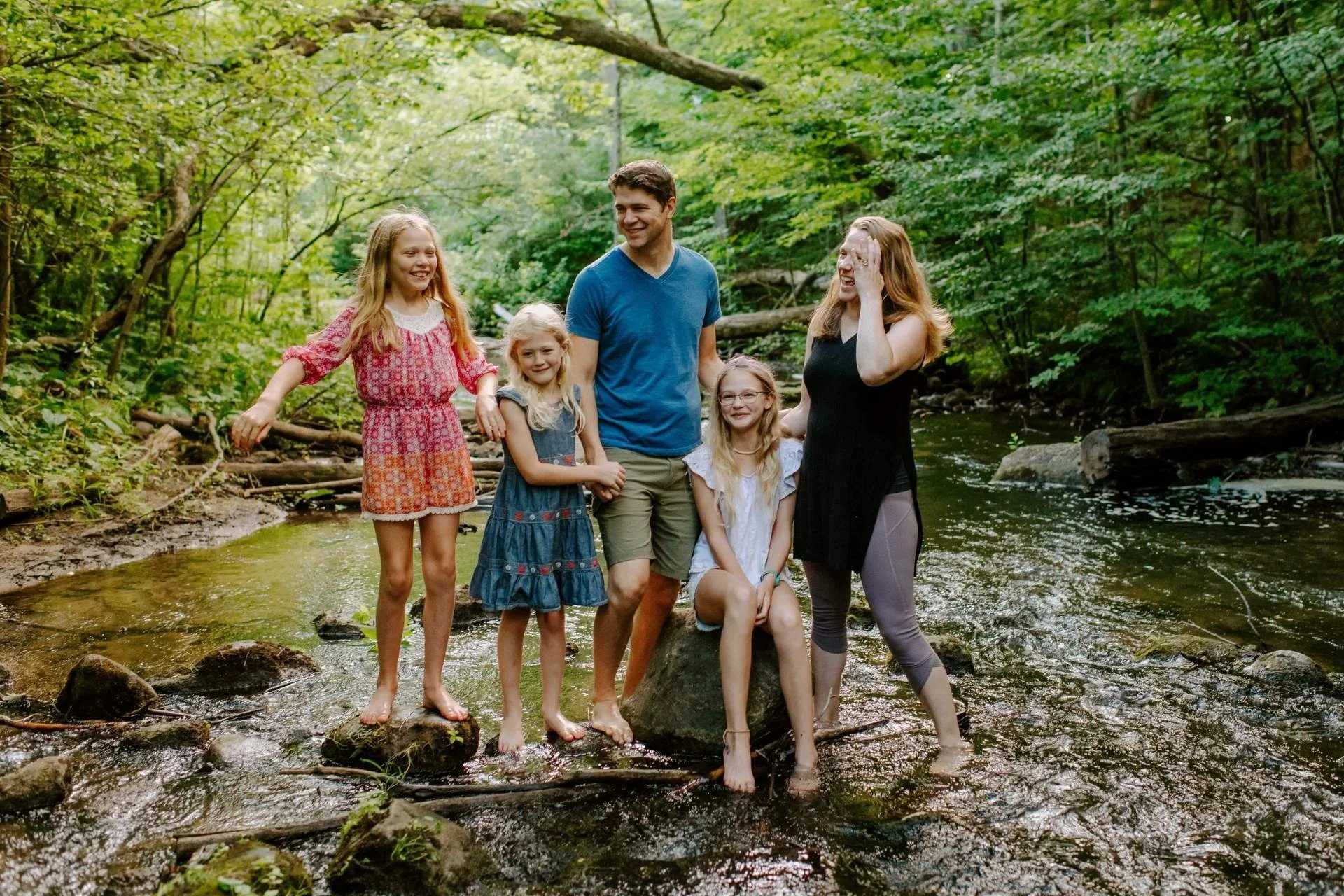 Cascade Home Repair owner in creek with family