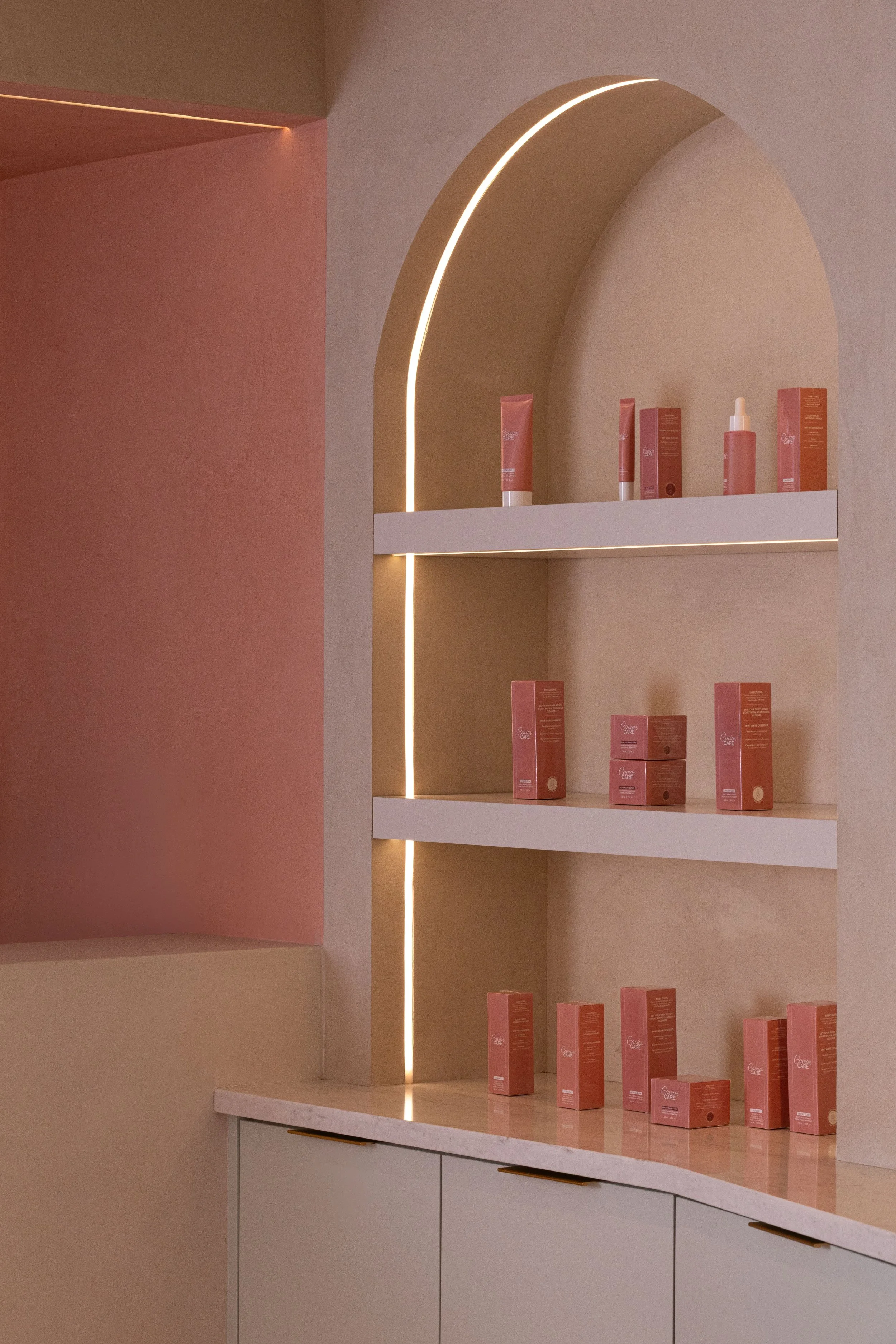 Wellness Interior design of Caviar Skin Clinic., a skin care clinic located in White Rock, British Columbia. Showing a detail of retail, featuring Caviar's own skin care products in an arched custom millwork.

best interior design in Vancouver