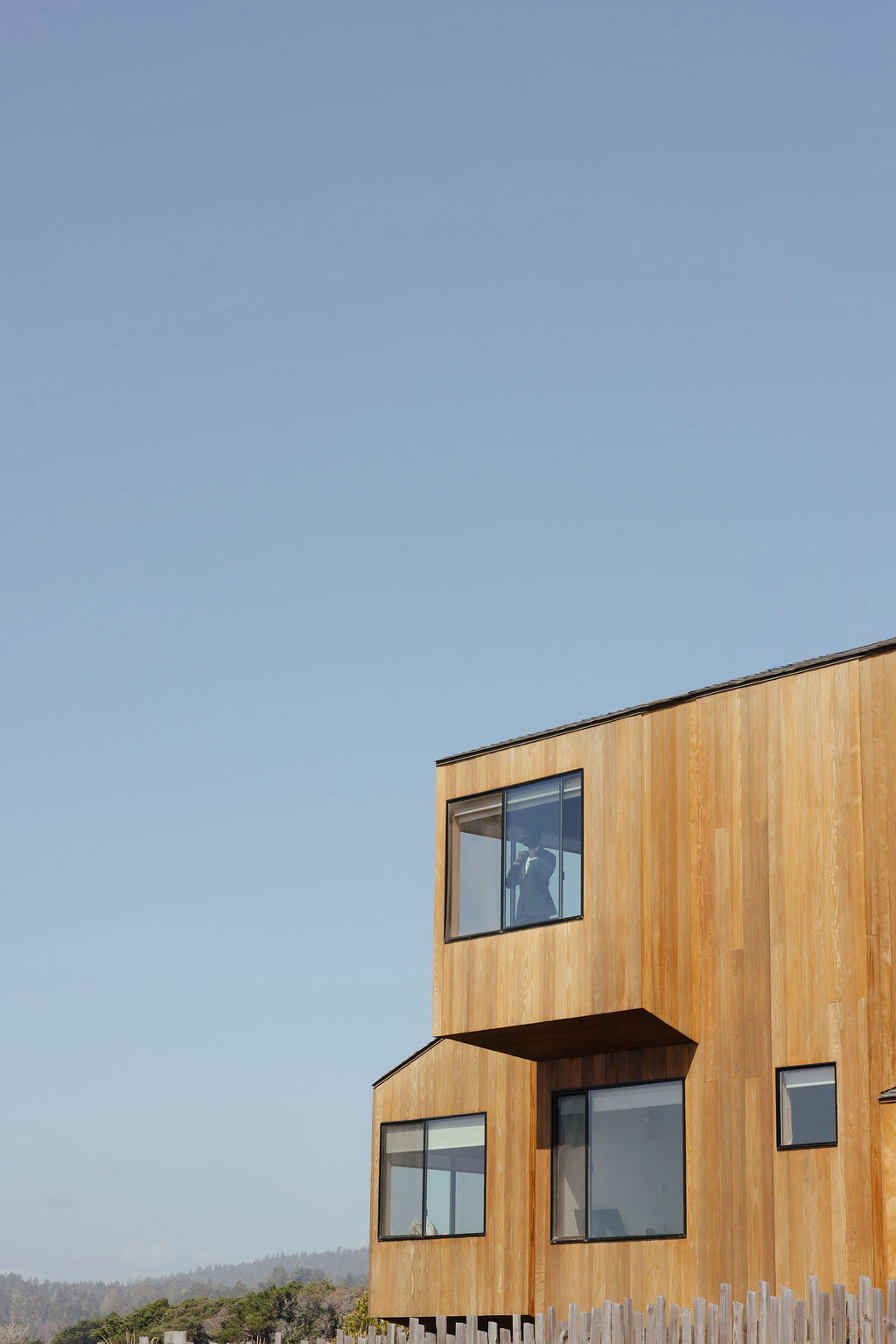 Intimate oceanfront wedding ceremony at Sea Ranch Lodge framed by architectural redwood cutout