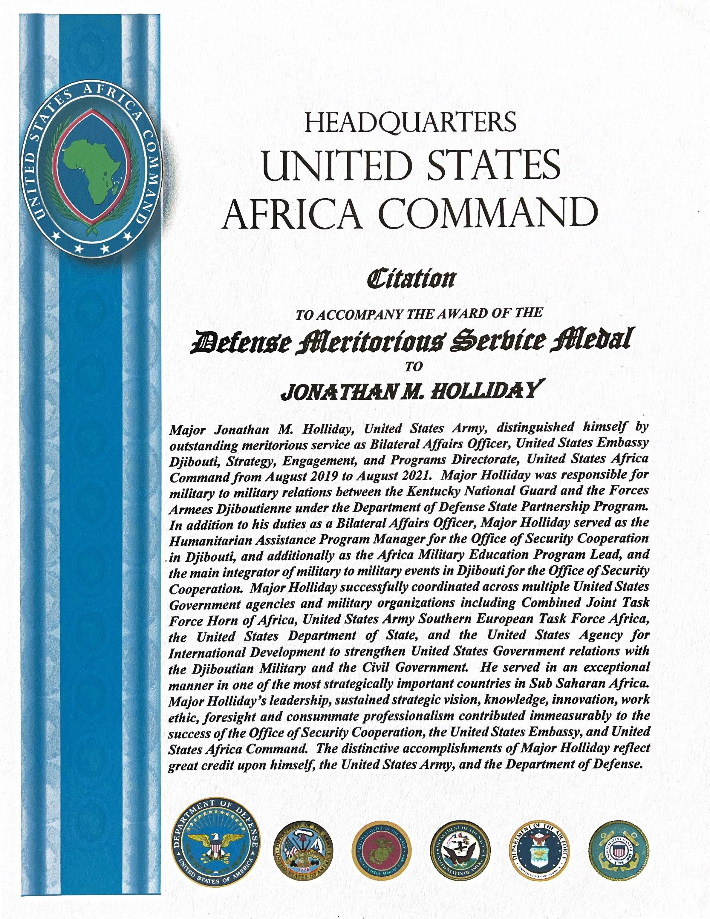 Certificate for Jonathan M. Holliday from the United States Africa Command, featuring the command's emblem, five military badges at the bottom, and a vertical blue band on the left side.