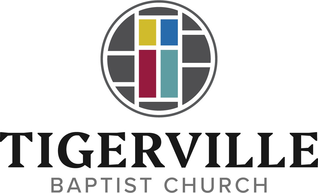 Logo of Tiggerville Baptist Church featuring a circular stained glass window with yellow, blue, red, and light blue panes, and the name of the church written below in bold and regular text.